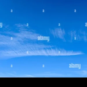 Clear blue sky with thin, wispy cirrus clouds stretching horizontally, suggesting calm weather and high-altitude winds.