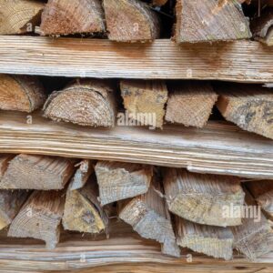 Neatly stacked firewood logs with rough-cut surfaces and natural wood grain, arranged in an orderly pile.