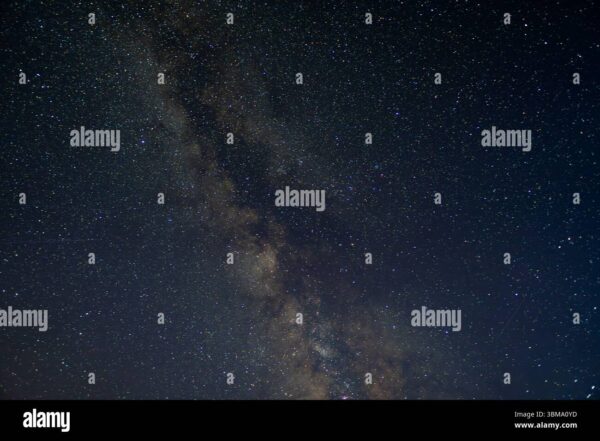 Wide view of the Milky Way galaxy stretching across a clear night sky filled with stars.